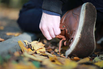 Autumn Park man walking along a path foliage