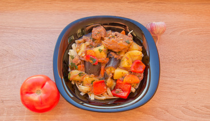 a plate of cooked dish lagman on a wooden table