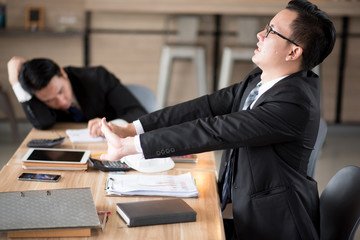 Asian businessman feels work with stress.
