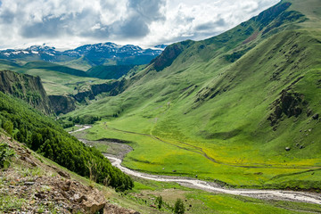 Fototapeta na wymiar High mountain valley surrounded by slopes of mountains.