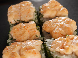 sushi rolls on gray stone slate on wood background