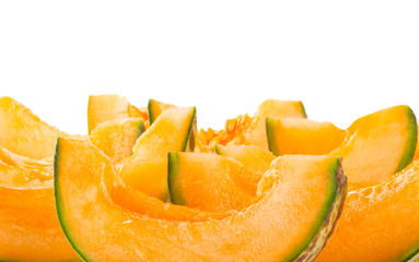 heap of slices of cantaloupe isolated on white background