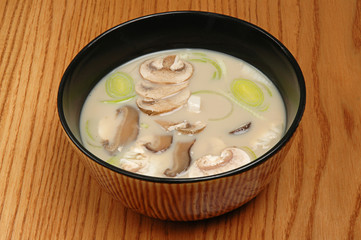 Japanese Cuisine - Miso Soup with Seaweed, Mushrooms and Tofu Cheese on a wooden table