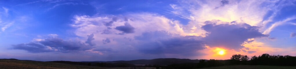 Decaying storm cloud during a sunset at summer evening