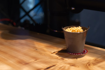 Bucket of potatoes. Beautiful serving of fried potatoes. A small bucket instead of a plate.