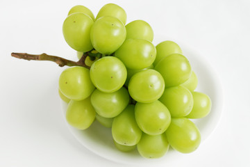 bunch of green grapes on white plate