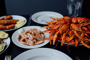 crawfish, shrimp and lobster on white plates