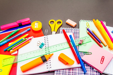 Naklejka premium Back to school concept. School education supplies on black stone concrete background.