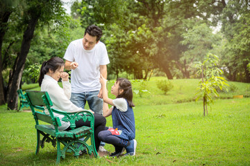 Unhappy,problems asian family,husband pointing at wife blaming her quarreling,parents quarrel,arguing child girl listen,mother,daughter crying,aggressive father,family conflict,violence in outdoor