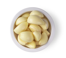 garlic in a bowl isolated on white background. top view