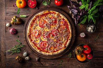 Tasty hot italian pizza with Tuna, Mozzarella cheese, Red onion, Tomatoes, Tomato sauce on old...