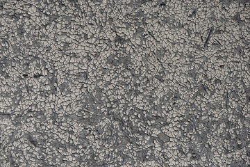 Old grungy wall with damaged plaster background texture.