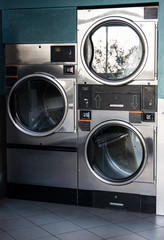 Several washing machines in public laundry.