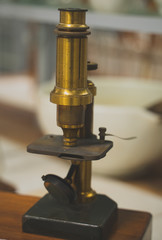 Retro golden microscope in the laboratory.