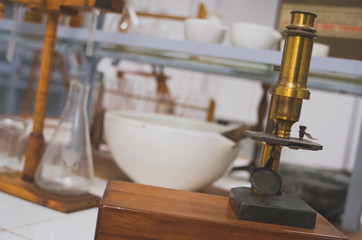 Retro golden microscope in the laboratory.