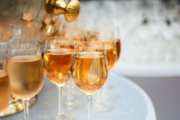 The beautiful wine glasses with rose wine