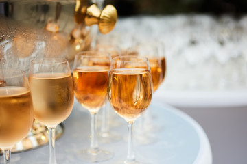 The beautiful wine glasses with rose wine
