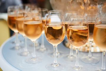 The beautiful wine glasses with rose wine