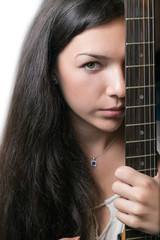Beautiful young woman holds guitar.