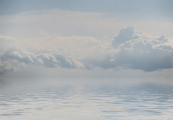 Sky with clouds reflected in water.