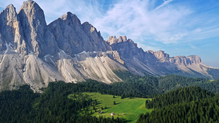 Aerial view of Dolomites Alps mountains in summer. Green forest around mountains, Val Di Funes, Santa Maddalena, Italy