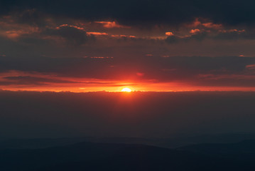 sunrise with clouds, hills silhouette and colorful sky