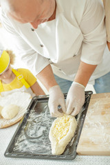 Children cook in the kitchen. Happy child learns to cook in the kitchen delicious chef chef. 