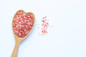 Pink himalayan salt on white.