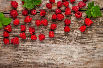 Ripe raspberry on an old wooden table. © Elena Blokhina