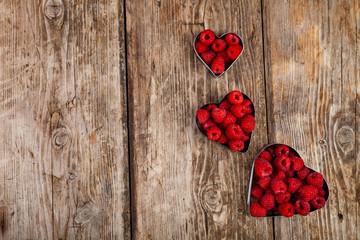 Fototapeta premium Ripe raspberries in the shape of a heart