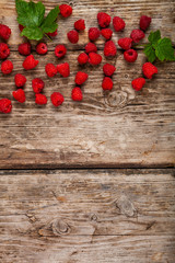 Ripe raspberry on an old wooden table.