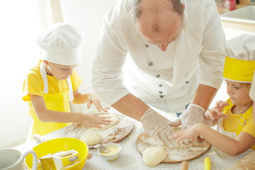 Children cook in the kitchen. Happy child learns to cook in the kitchen delicious chef chef. 