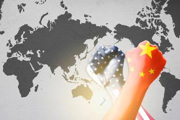Print screen USA and China flag on hand across wrestle on world map background.United States of...