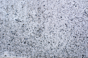 Detail of a gray wall close up. Cinderblock garage, detailing the outside of the garage wall