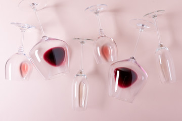 Assorted wineglasses with red, rose and white wine lying on pink background. Wine degustation concept. Flat lay. Top view. Copy space