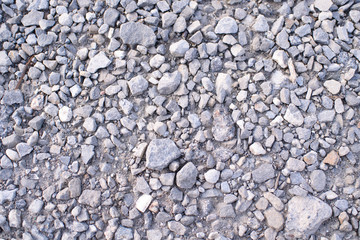 Ground stone gray background of a large number of small stones