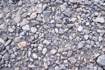Ground stone gray background of a large number of small stones