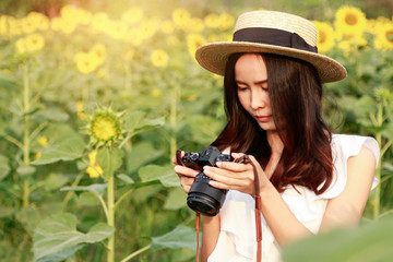 Girl looking at camera with in sunflowers field 