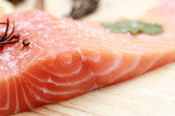 Raw salmon slices with ingredient for cooking on kitchen plate 