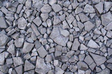 Ground stone gray background of a large number of small stones