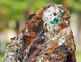 Fototapeta na wymiar Raw mineral malachite and hematite with green background