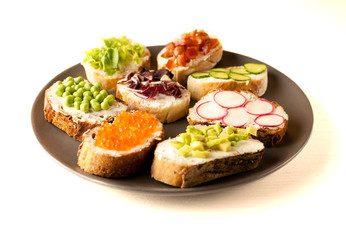 sandwiches or tapas prepared with bread and tasty ingredients. Could be nice food for healthy breakfast ot lunch. Copy space for your text
