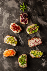 Brushetta or traditional spanish tapas. Appetizers italian antipasti snacks set on wooden board. Top view and flat lay with space for your text.Christmas tree