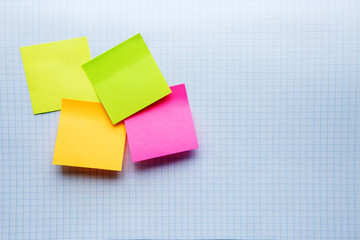 multi-colored sheets for notes on a notebook sheet. question mark. colored stickers.