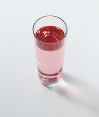 Glass of rose liquid on white background, São Paulo, Brazil