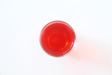 Glass of red liquid on white background, São Paulo, Brazil