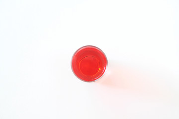Glass of red liquid on white background, São Paulo, Brazil