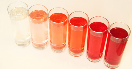 Five glasses of red liquid on white background, São Paulo, Brazil