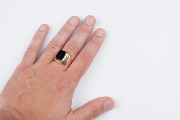 Men's golden ring on his hand isolated on a white background