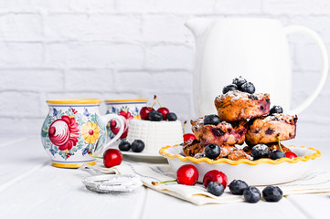 Homemade pastries with ricotta and berries. cheese cake for breakfast. Italian food on a white background. Healthy baking and proper nutrition. Copy space.